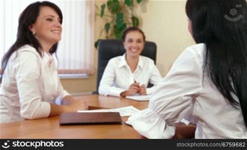 Friendly Business Women Discussing In A Meeting, Focus on Foreground