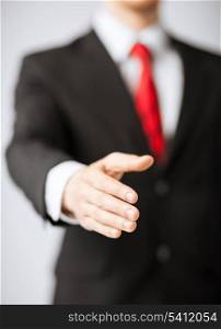 friendly businessman with open hand ready for hugging