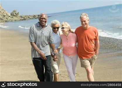 Friendly Couples Walking Together on Beach