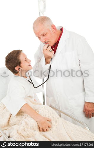 Friendly doctor entertains a young patient by blowing in the stethoscope. Isolated on white.