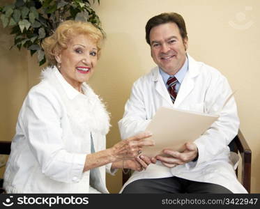 Friendly doctor going over a senior patient&rsquo;s chart with her.