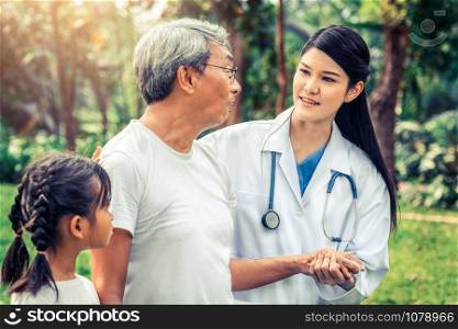Friendly doctor taking care of senior man in the hospital garden. Medical and healthcare doctor service concept.