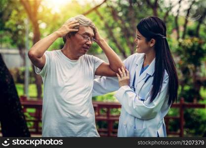 Friendly doctor taking care of senior man in the hospital garden. Medical and healthcare doctor service concept.. Friendly doctor taking care of senior man.