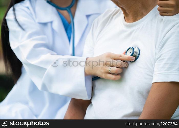 Friendly doctor taking care of senior man in the hospital garden. Medical and healthcare doctor service concept.. Friendly doctor taking care of senior man.