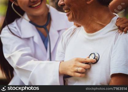Friendly doctor taking care of senior man in the hospital garden. Medical and healthcare doctor service concept.
