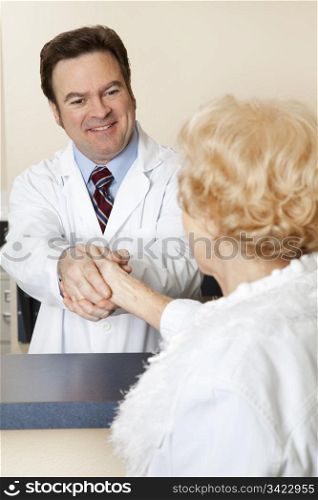 Friendly doctor welcoming a new patient with a handshake.