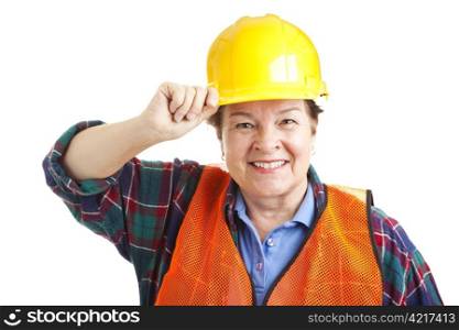 Friendly female construction worker tips her hard hat. Closeup portrait solated on white.