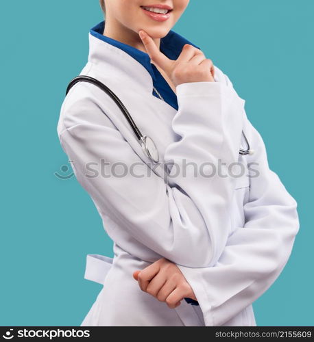 Friendly female doctor - isolated over a blue background. Friendly female doctor