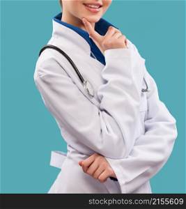 Friendly female doctor - isolated over a blue background. Friendly female doctor