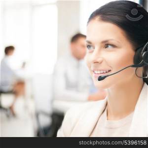 friendly female helpline operator with headphones in call center