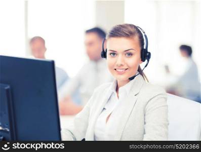 friendly female helpline operator with headphones in call centre. helpline operator with headphones in call centre