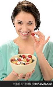 Friendly girl posing with cereal bowl and berries