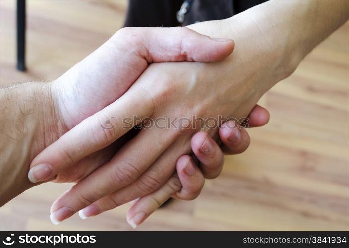Friendly handshake. Man and woman shaking hands as welcoming gesture.