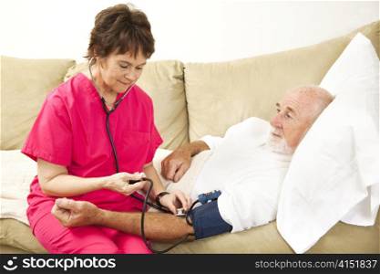 Friendly home health nurse taking the blood pressure of an elderly patient.