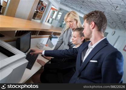 friendly hotel workers at reception desk