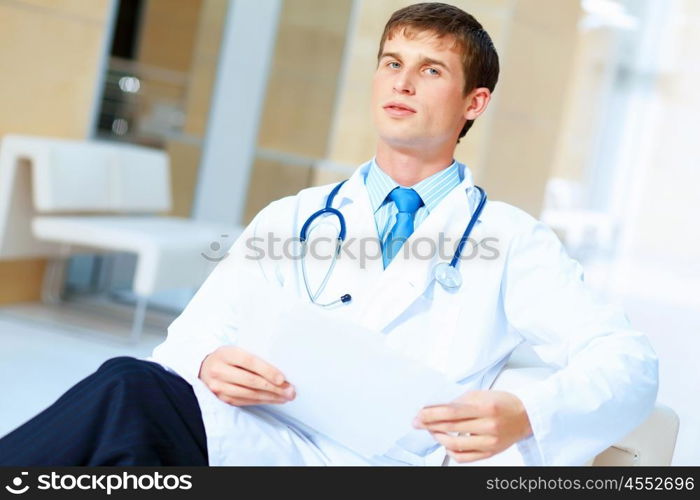 friendly male doctor. Portrait of friendly male doctor in hospital smiling