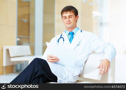 friendly male doctor. Portrait of friendly male doctor in hospital smiling