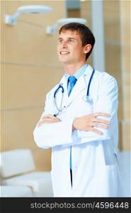friendly male doctor. Portrait of friendly male doctor in hospital smiling
