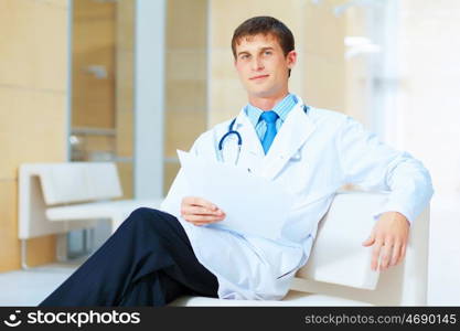 friendly male doctor. Portrait of friendly male doctor in hospital smiling