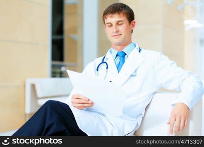 friendly male doctor. Portrait of friendly male doctor in hospital smiling