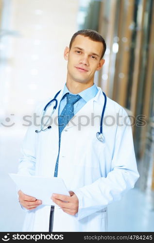 friendly male doctor. Portrait of friendly male doctor in hospital smiling