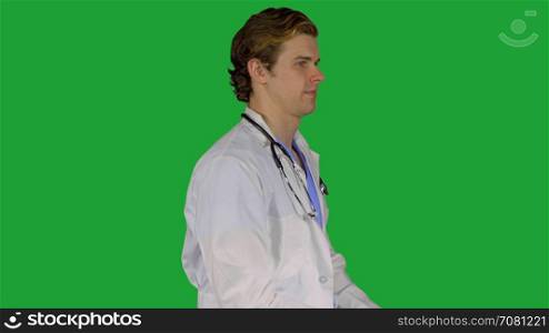 Friendly male doctor turns to camera (Green Key)