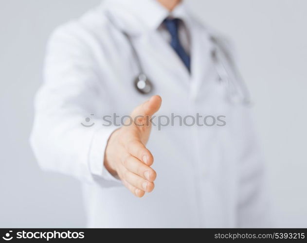 friendly male doctor with open hand ready for hugging