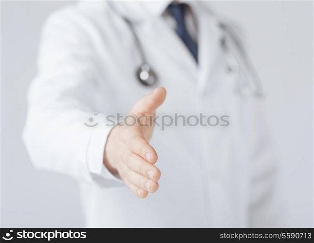 friendly male doctor with open hand ready for hugging