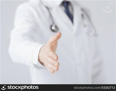 friendly male doctor with open hand ready for hugging