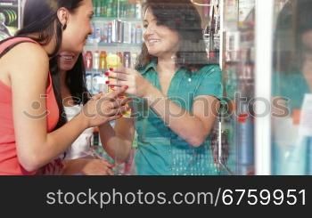 Friendly shop representative offers goods to a buyer in the cosmetics department