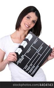Friendly woman with a clapperboard