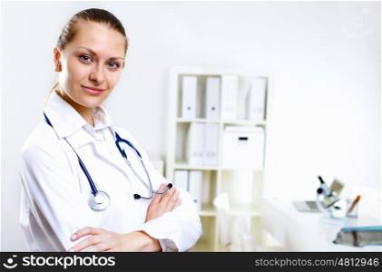 Friendly young female doctor in uniform in medical office