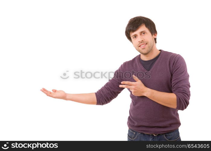 friendly young man pointing to his side and looking into the camera. isolated on white background. presenting