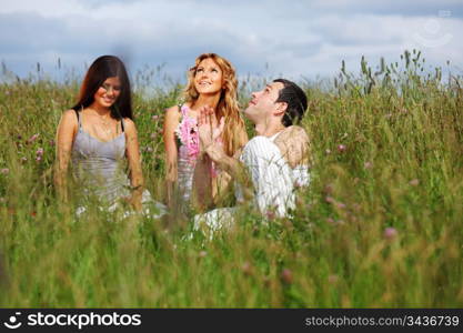 friends and dog in green grass field