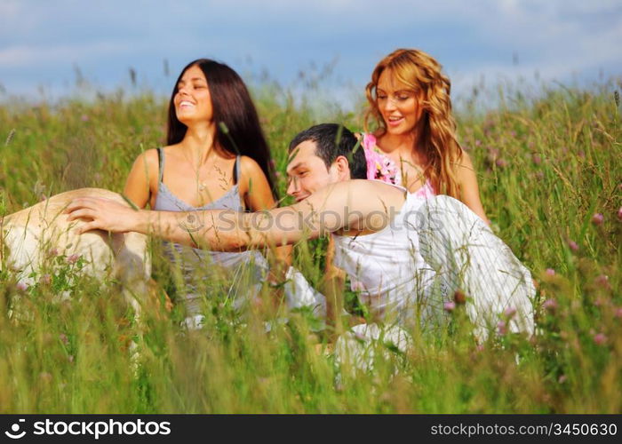 friends and dog in green grass field