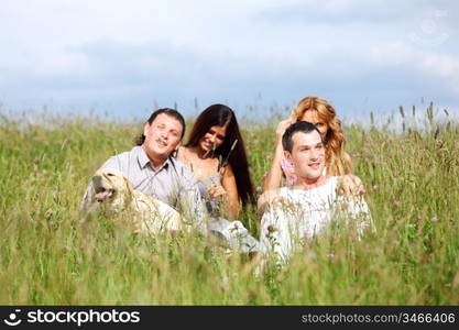 friends and dog in green grass field