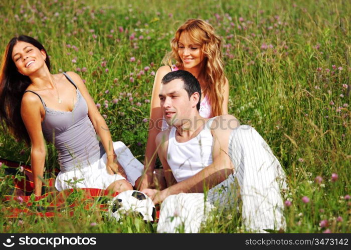 friends and dog in green grass field