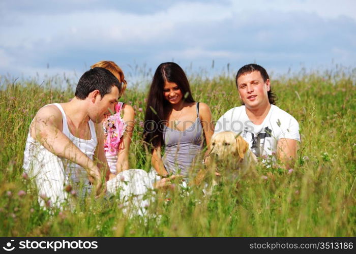 friends and dog in green grass field