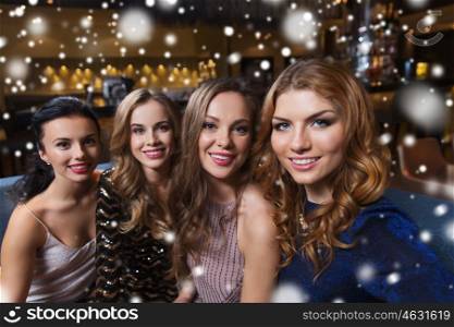 friends, bachelorette party, technology and holidays concept - happy smiling young pretty women taking selfie at night club