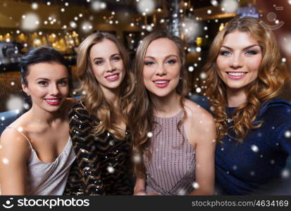 friends, bachelorette party, technology and holidays concept - happy smiling young pretty women taking selfie at night club