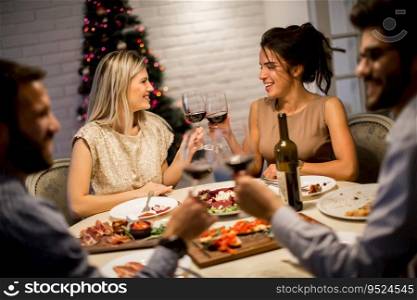 Friends ce≤brating Christmas or New Year eve at home