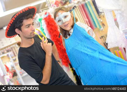 friends dressing up in fancy dress shop