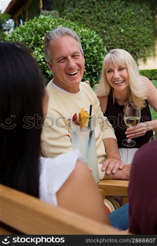 Friends drinking wine in garden