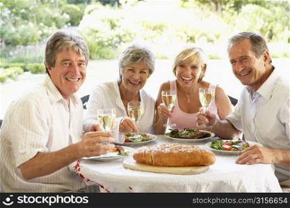 Friends Eating An Al Fresco Lunch, Holding Wineglasses