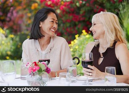 Friends Enjoying a Glass of Wine at a Garden Party