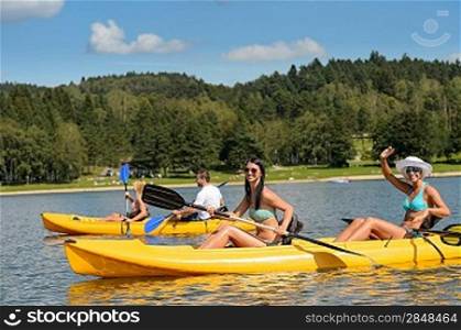 Friends enjoying summertime kayaking on river holiday freetime