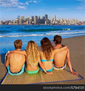 friends group couples sitting in beach sand rear view San Francisco skyline photo mount
