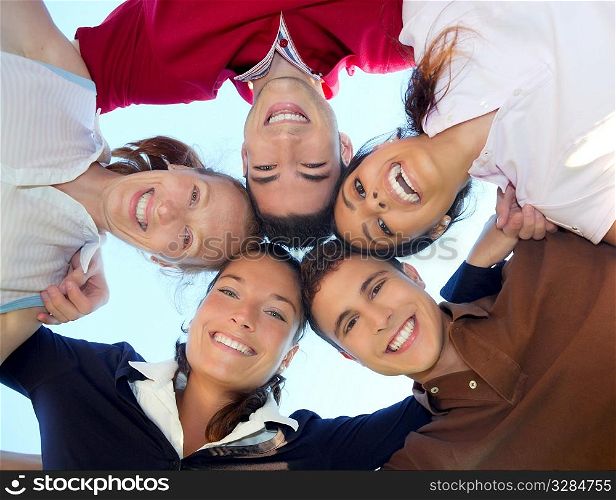 friends happy group in circle heads smiling together from below view