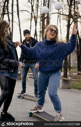 friends having fun skateboarding outdoors park