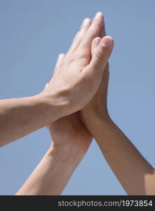 friends high fiving outside after coronavirus